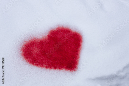 red heart painted on snow with paint from a pulverizer  graffiti for valentine s day february 14  winter heart