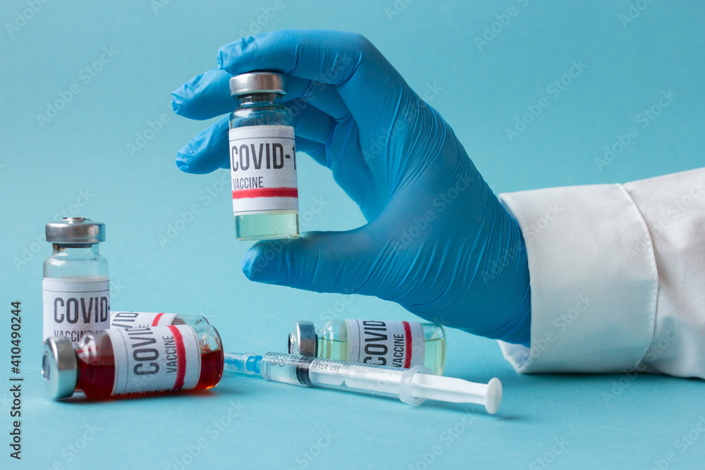 Covid-19 or coronavirus vaccine in doctor hands, nurse in blue gloves holding ampoule and syringe