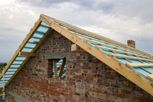 Wallpaper Mural Aerial view of a brick house with wooden roof frame under construction. Torontodigital.ca