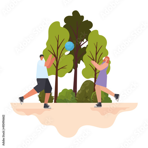 man and woman playing basketball on a park