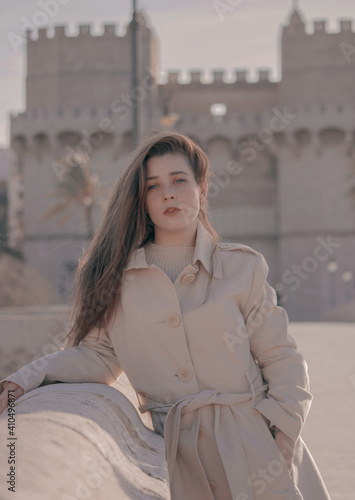 Gorgeous blue eyed brunette hair young leaning on the bridge of Valencia posing and looking at the camera with the famous Quart Towers in the background. © CristianUrriaga