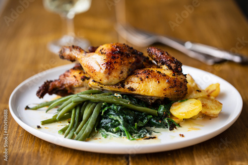 Roasted poussin with potatoes, mashed swede, green beans and creamy spinach