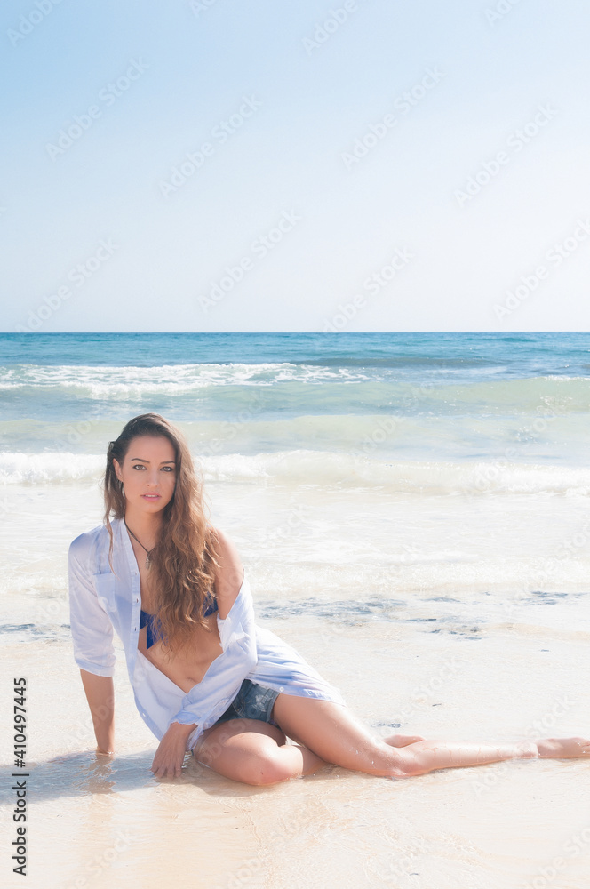 very attractive and sensual young woman enjoying the sun on the seashore in spring or summer very attractive and sensual young woman enjoying the sun on the seashore in spring or summer