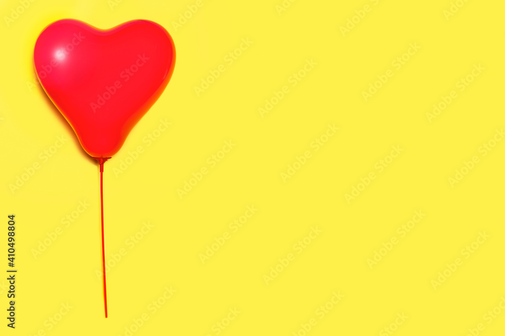 Balloon in the shape of a heart on a stick. Red helium balloon.