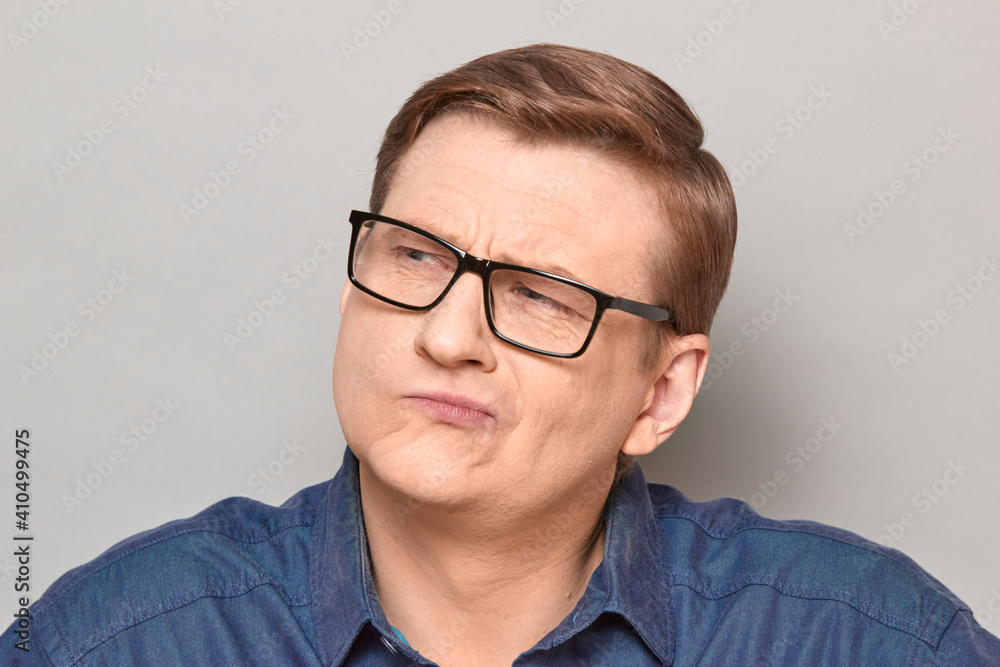 Portrait of thoughtful serious mature man with glasses