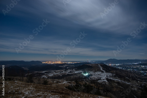 Panorama of a winter village at night in the mountains