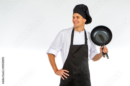Young cook is holding a fry...