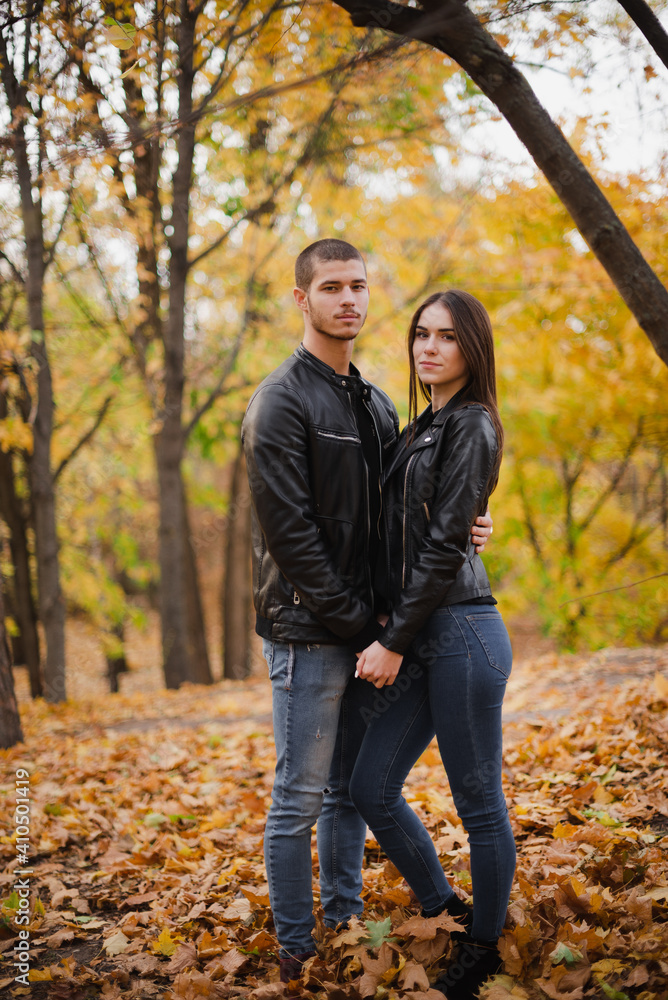 The guy with the girl lovers walk in the park autumn The guy with the girl lovers walk in the park autumn
