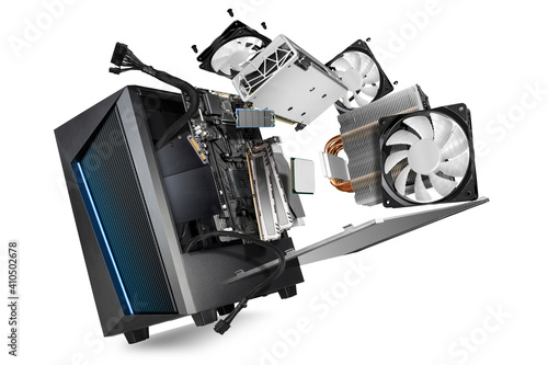 flying parts of a modern computer. hardware components mainboard cpu processor graphic card RAM cables and cooling fan flying out of black blue PC case isolated abstract technology background photo