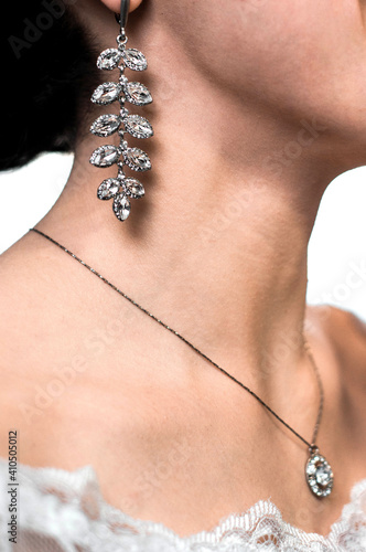 bride in earrings and diamond pendant