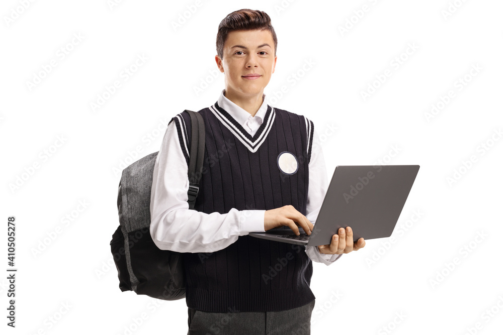 Teenage student in a school uniform holding a laptop computer Teenage student in a school uniform holding a laptop computer