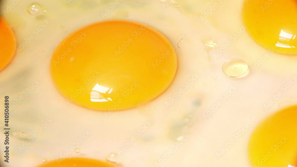 frying raw chicken eggs in a skillet for breakfast frying raw chicken eggs in a skillet for breakfast