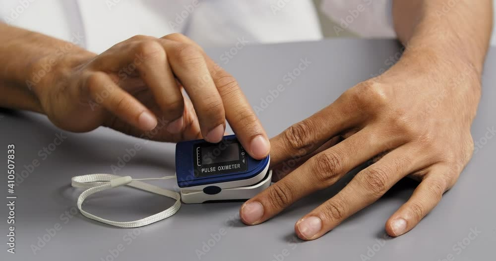 Cropped shooting afro americam man with dark skin put on pulse oximeter
