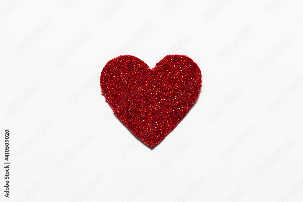 Red glitter heart on white background