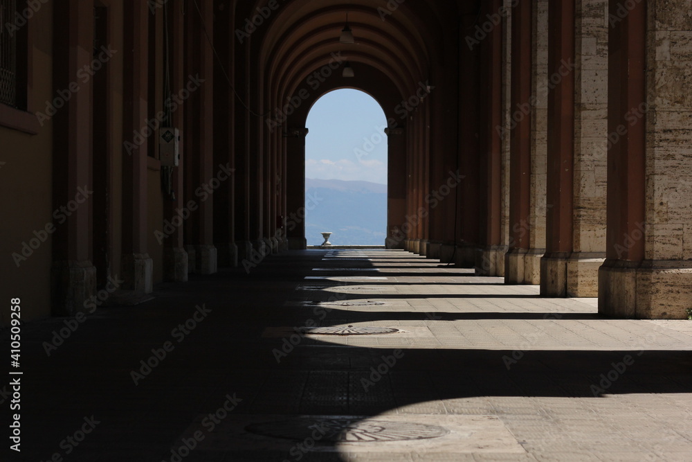 Arched columns, colonnade  with shadows in the city of Perugia 