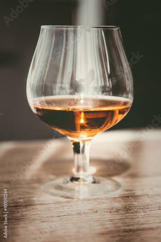 a glass of elite cognac on the bar