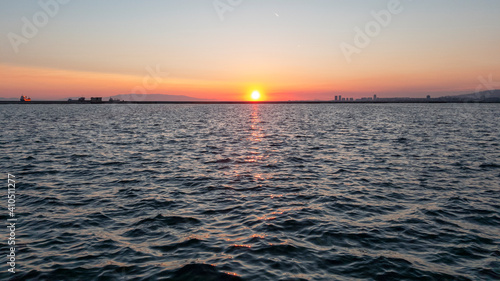 Colorful sunset with sea and sun on the horizon. Izmir, Turkey. photo