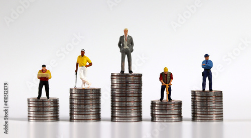 Принти на полотні Various miniature people standing on piles of coins of different heights