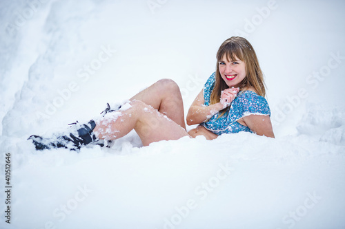 Beautiful smiling confident young white woman pretty face in snow alone at winter forest. hardening the body photo