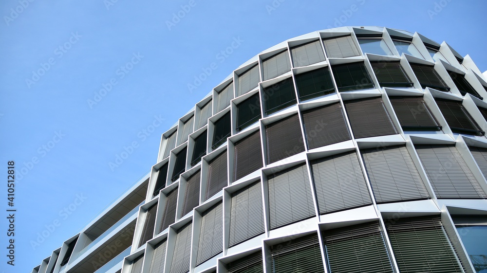 Glass facade of the buildings with a blue sky. Skyscrapers in the business city center.. Background of modern glass buildings. Glass facade of the buildings with a blue sky. Skyscrapers in the business city center.. Background of modern glass buildings.