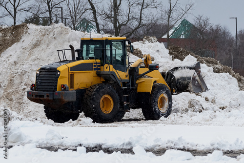 yellow snow plow tractor