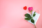 Rose and face mask for Valentine's day and COVID-19 protection concepts.Selective focus with copy space