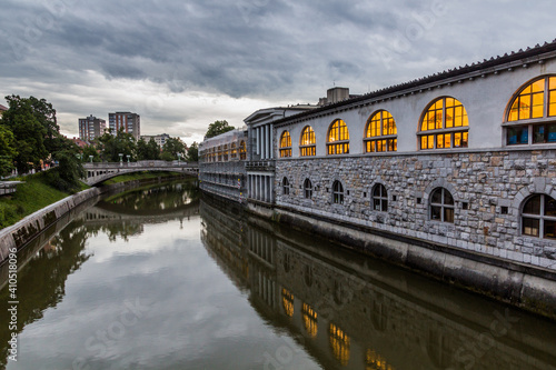 Plecnik arcade market building reflecting in Ljubljanica river in Ljubljana, Slovenia