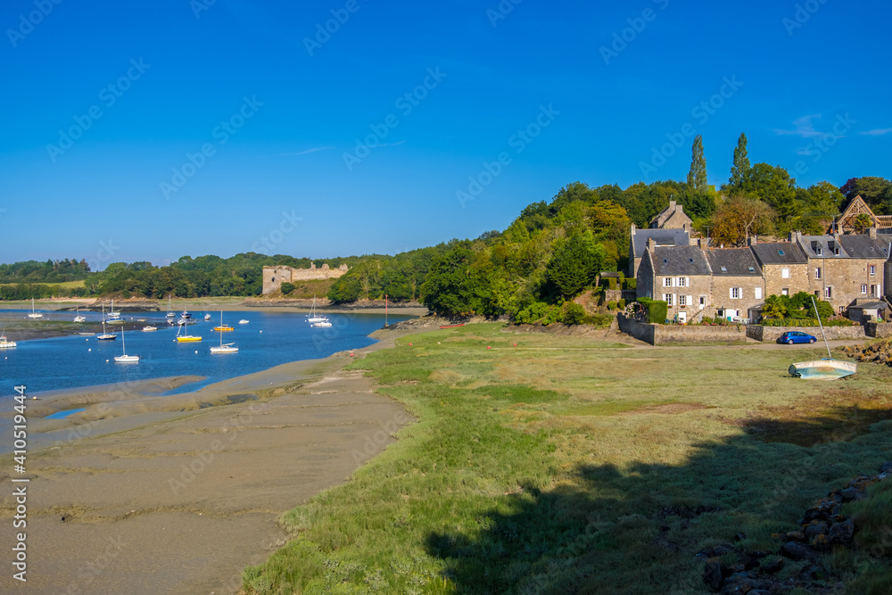 Saint-Cast Le Guildo, France - August 25, 2019: The Harbor of Guildo and Chateau du Guildo at low tide in the coastal river L'Arguenon in Brittany