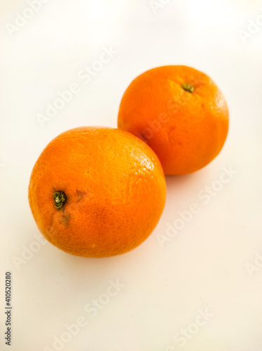Two oranges on the white table.

Zagreb, Croatia - February 1st 2021