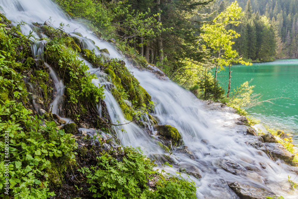Waterfall and a hiking trail around Crno jezero lake in Durmitor mountains, Montenegro Waterfall and a hiking trail around Crno jezero lake in Durmitor mountains, Montenegro