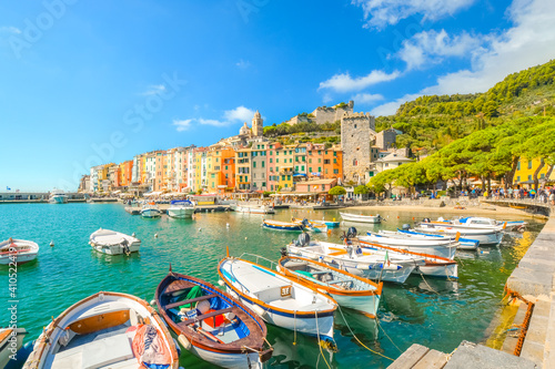 Boats line the harbor of the colorful  touristic Italian city of Portovenere  along the Ligurian Coast of the Italian Riviera.