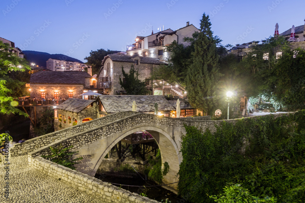 Evening view of Kriva cuprija (Crooked bridge) in Mostar. Bosnia and Herzegovina