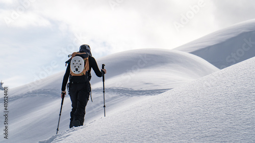 female skier climbing a mountain  photo