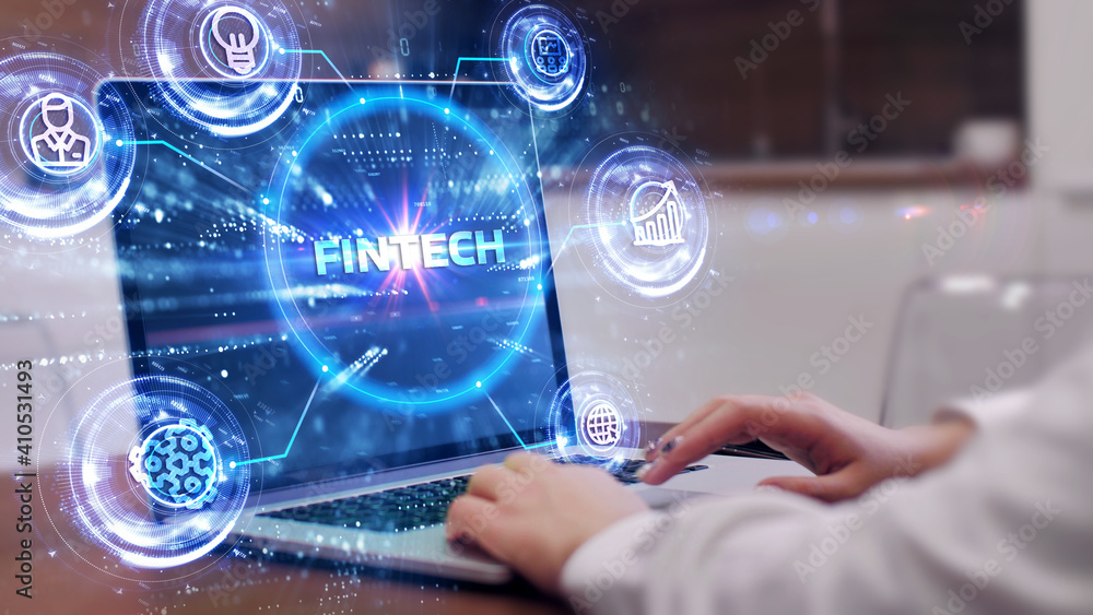 Fintech -financial technology concept.Young businessman select the icon Fintech on the virtual display. Fintech -financial technology concept.Young businessman select the icon Fintech on the virtual display.