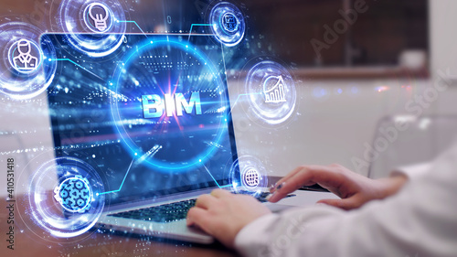 The concept of business, technology, the Internet and the network. A young entrepreneur working on a virtual screen of the future and sees the inscription: BIM