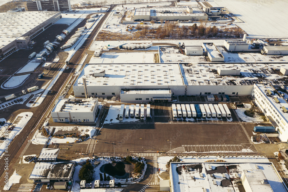 Aerial view of the trucks unloading at the logistic center. Drone photography. Aerial view of the trucks unloading at the logistic center. Drone photography.