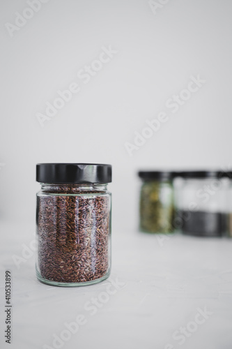 seed jars with sesame poppy pupmkin chia and flax seeds as important nutrient sources for nutrition shot on white background photo