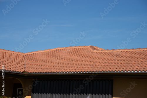 View of red roof tiles and sky on the background