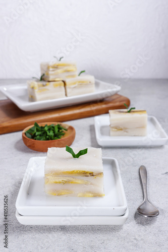 Nagasari loyang or cake pan nagasari, Indonesian traditional steamed snack made from rice flour, coconut milk, banana and served slices. photo