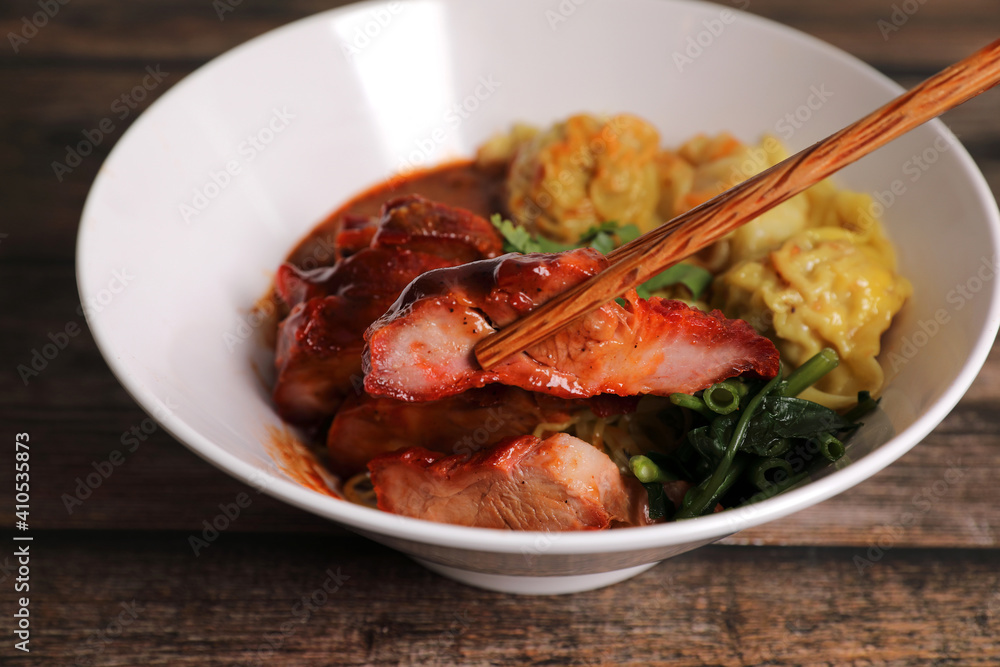 Shrimp dumpling with roasted pork with local thai tom yum spicy sauce on wood background Shrimp dumpling with roasted pork with local thai tom yum spicy sauce on wood background