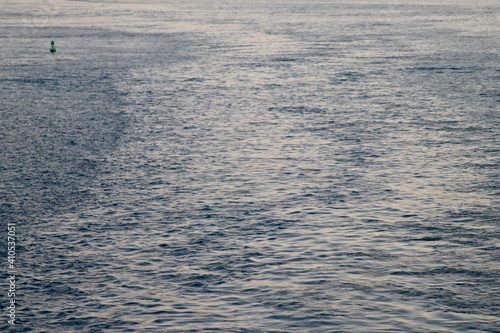 Water trail behind a ship in ocean