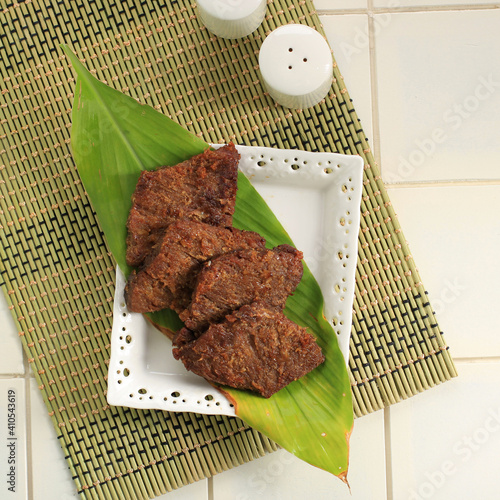 Empal gepuk or sometimes simply known just as empal or gepuk is an Indonesian sweet and spicy fried beef dish abd commonly popular in Java island, but can trace its origin to Sundanese cuisie. photo