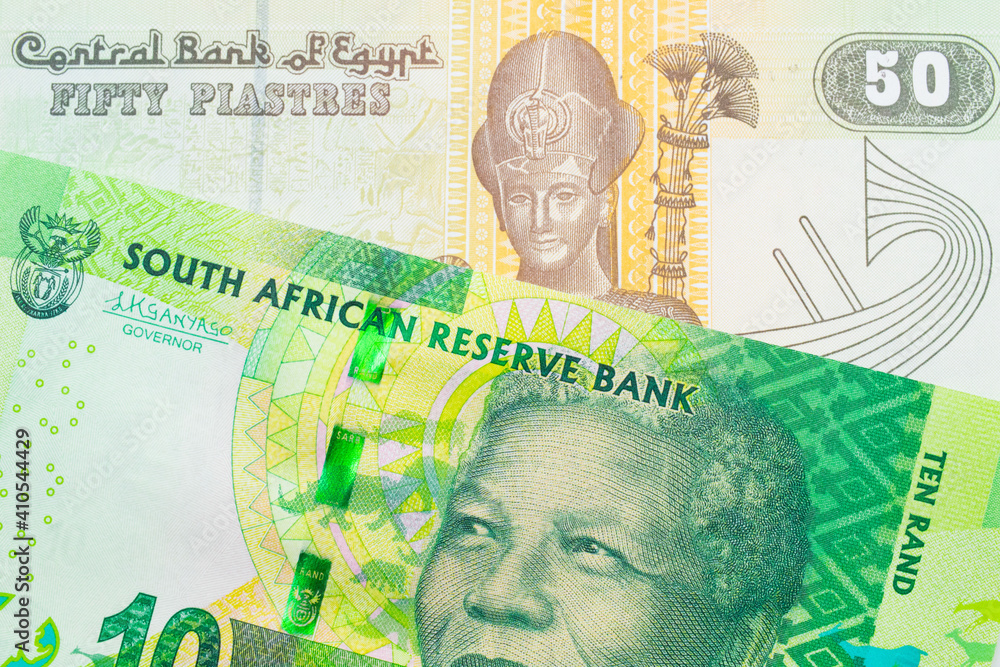 A macro image of a shiny, green 10 rand bill from South Africa paired up with a green and yellow fifty piastre note from Egypt.  Shot close up in macro.