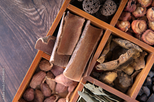 Looking down at all kinds of traditional Chinese medicine in wooden box photo