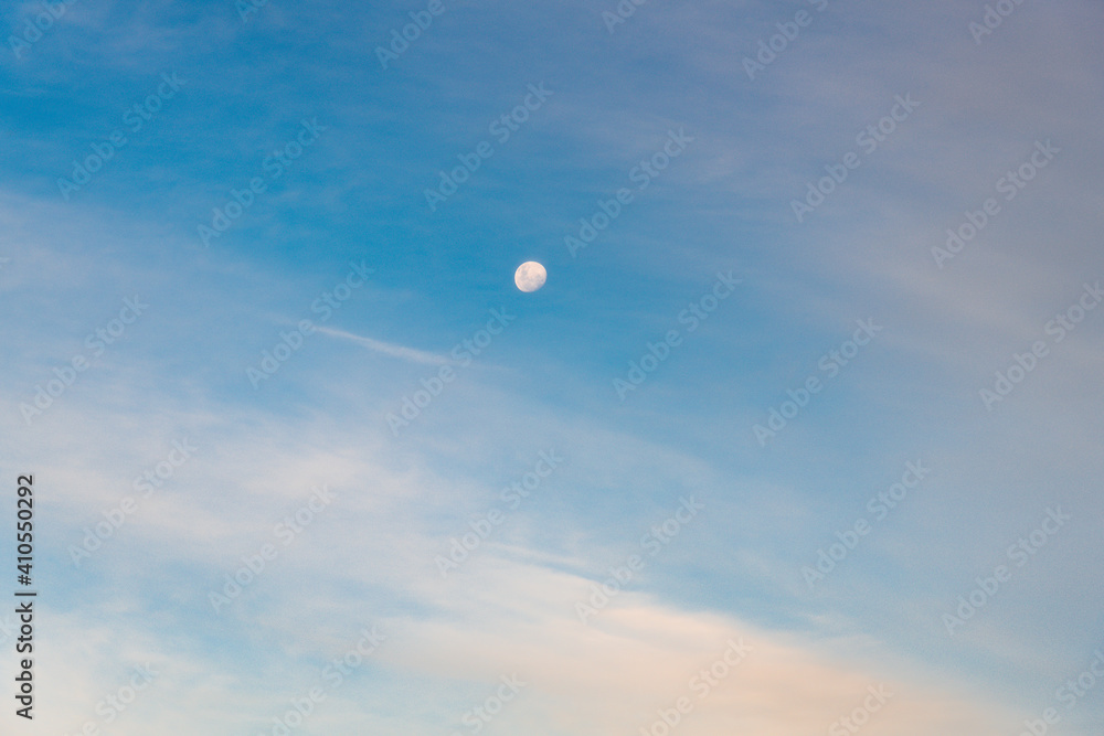 White clouds and the moon in a blue sky White clouds and the moon in a blue sky