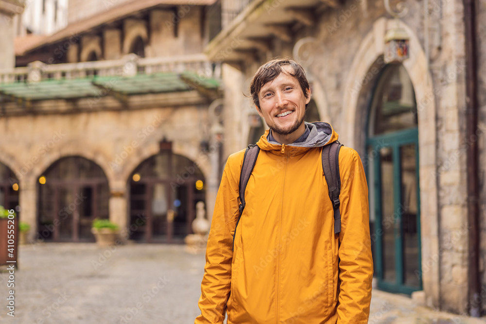 Fototapeta premium Young man tourist walks down the street in a European city after the end of COVID-19 coronavirus. quarantine is over