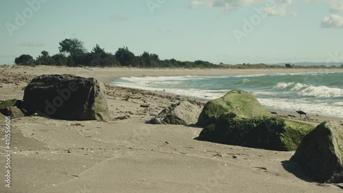 Beach landscape with rocks and waves in Whakatane, New Zealand. photo