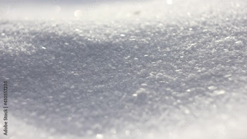 Background of sparkling snow falling quietly on a snowdrift close-up 1920x1080. Snow. Falling snowflakes in a natural environment. The concept of winter design. Falling snow sparkling in the sun macro Background of sparkling snow falling quietly on a snowdrift close-up 1920x1080. Snow. Falling snowflakes in a natural environment. The concept of winter design. Falling snow sparkling in the sun macro