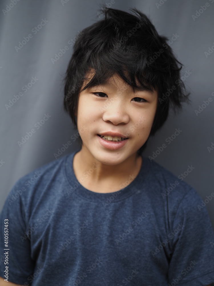 Funny portrait of 11 years old asian boy with dark blue t shirt Funny portrait of 11 years old asian boy with dark blue t shirt