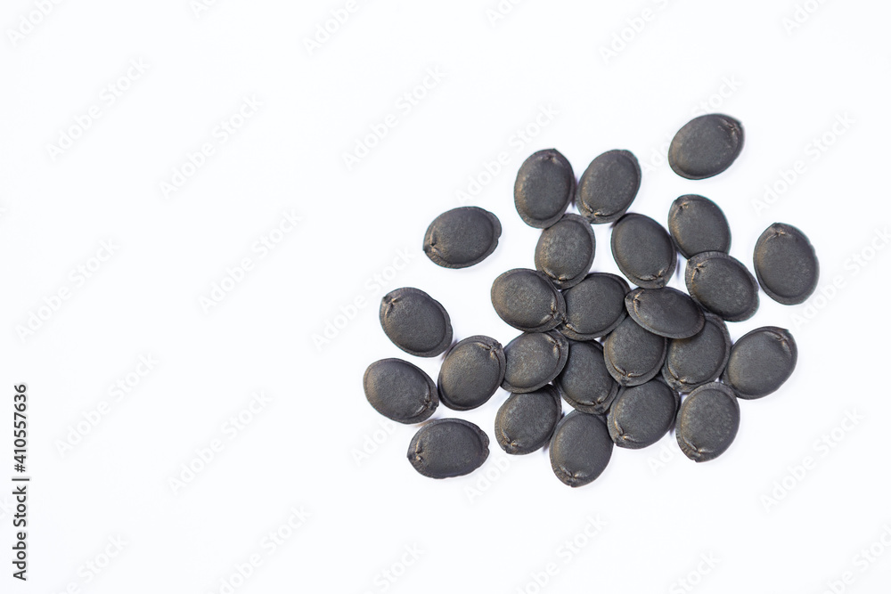Black seeds, Dried gourd luffa seed on white background Black seeds, Dried gourd luffa seed on white background